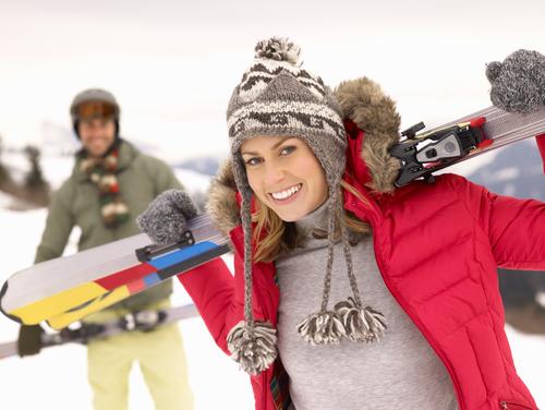 woman-holding-skis-slope